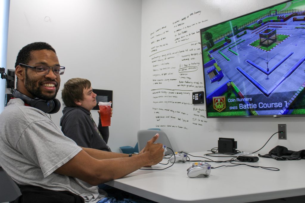 Student playing video game during esports club tournament