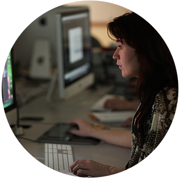 Woman looking at computer with hands on mouse and keypad