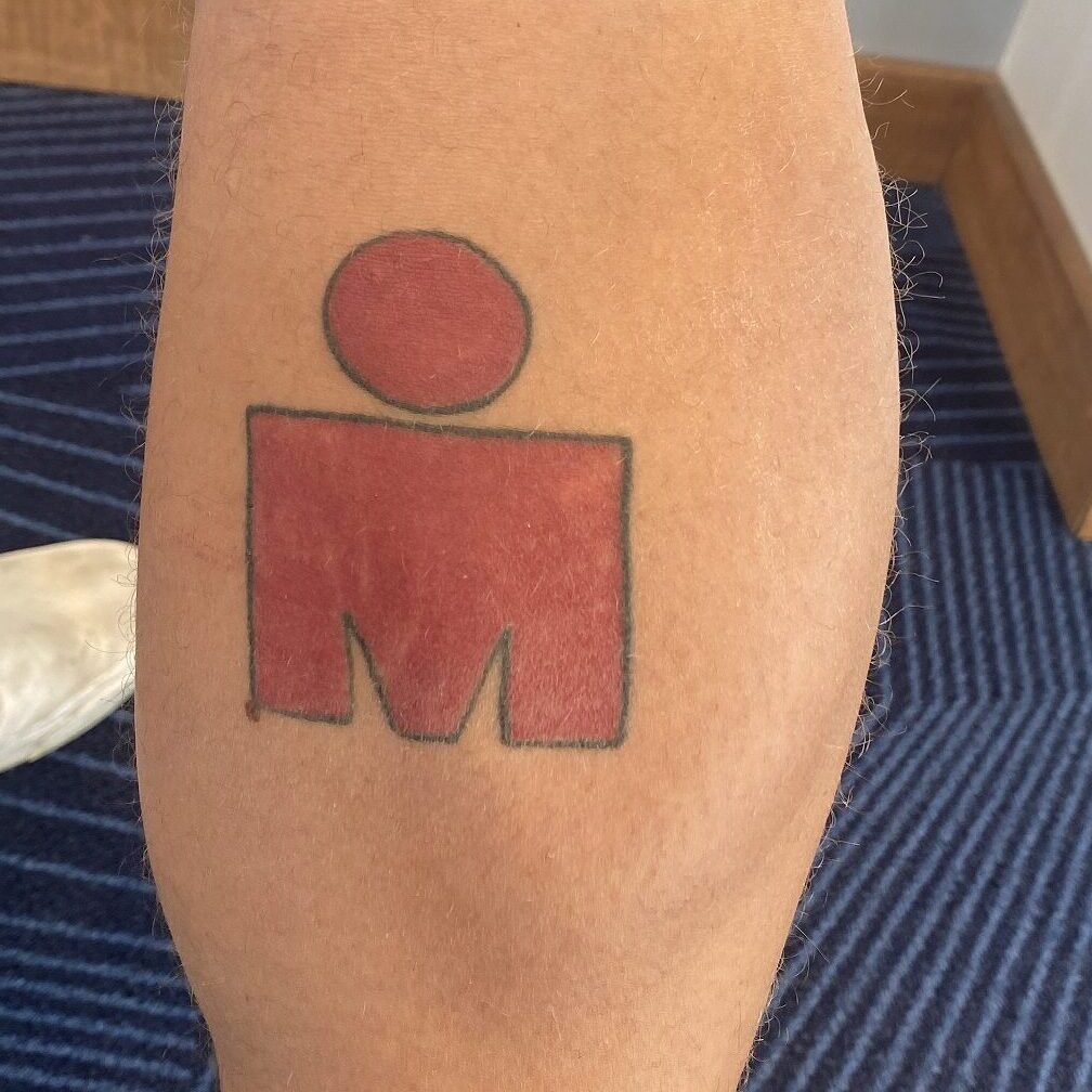 A tattoo of the Ironman logo on the calf of Grant Heidebrecht.