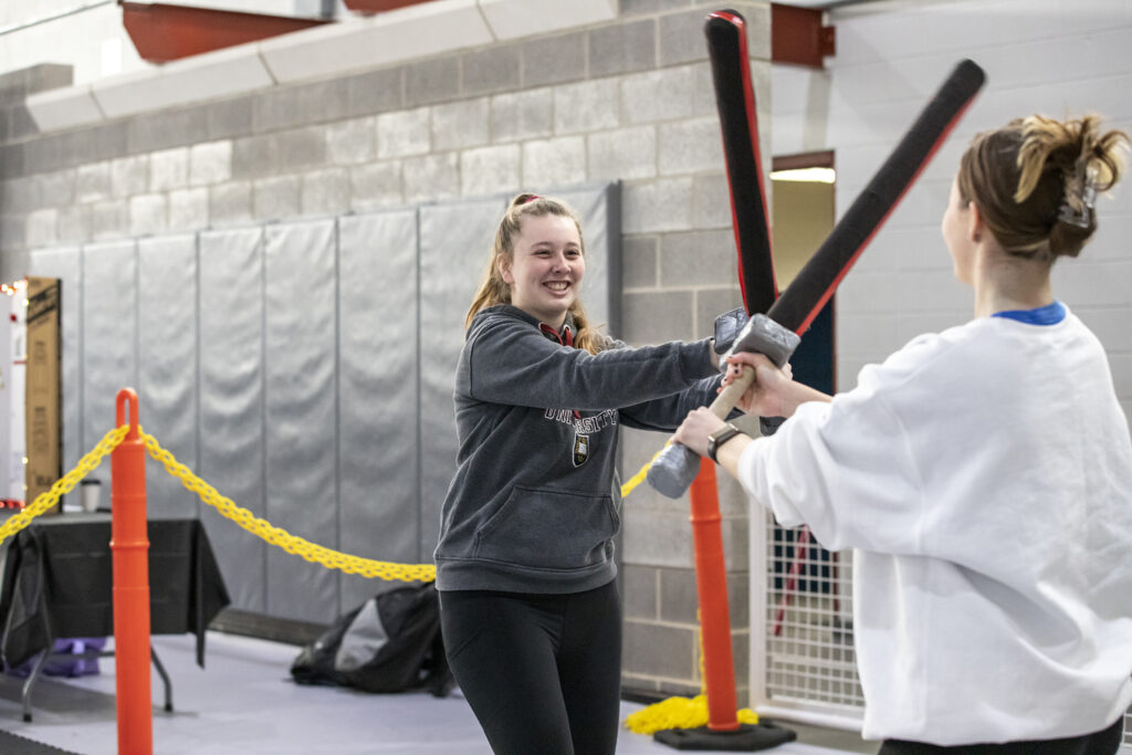 Girls sword fighting with Comitatus at the activities fair