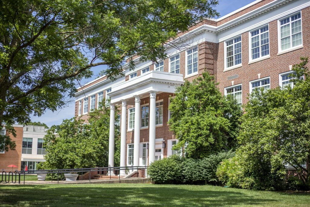 Bowman Hall at Bridgewater College on a bright sunny day surrounded by green trees and bushes