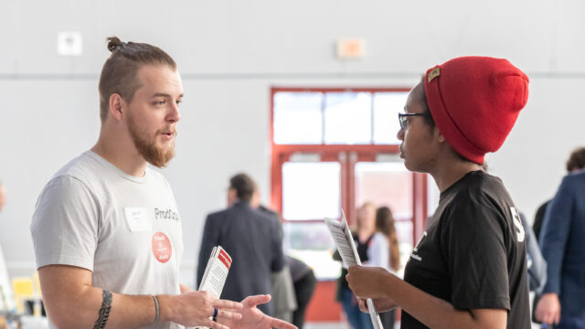 Employer speaking with student at career exploration day