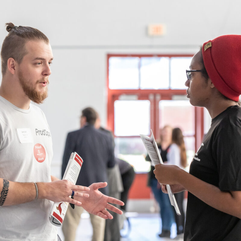 Employer speaking with student at career exploration day