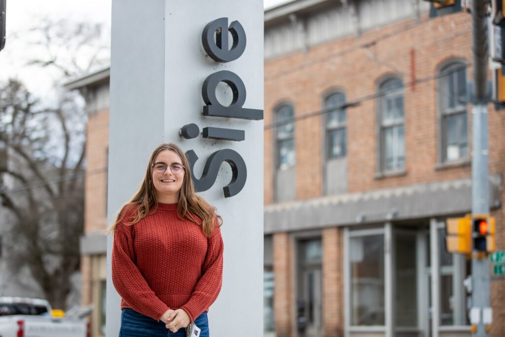 MaryBeth Killian standing outside in front of a sign that says Sipe