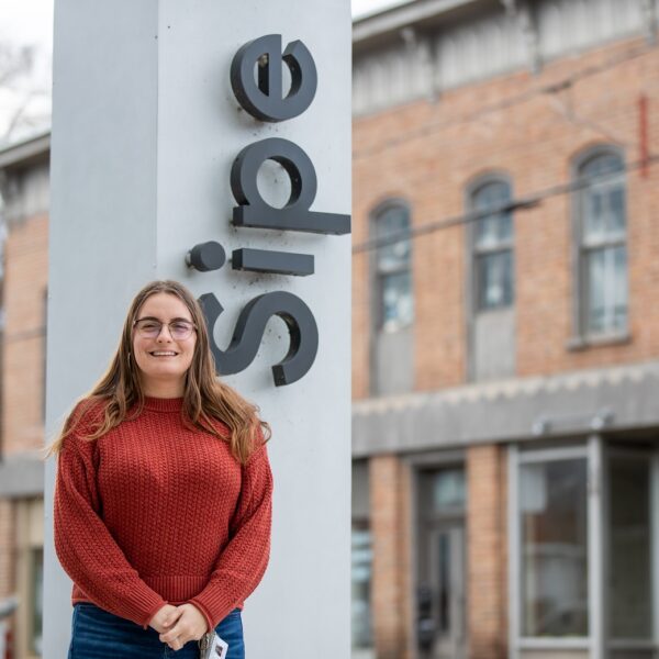 MaryBeth Killian standing outside in front of a sign that says Sipe