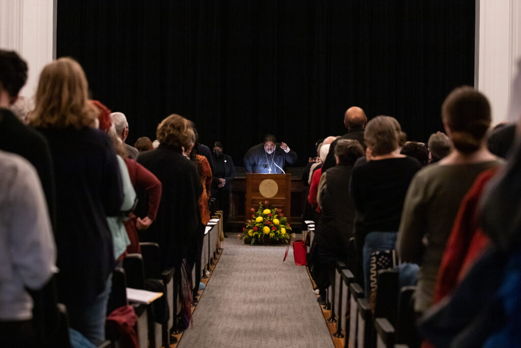 Rev. Dr. William J. Barber II standing behind podium pointing at the crowd at his endowed lecture