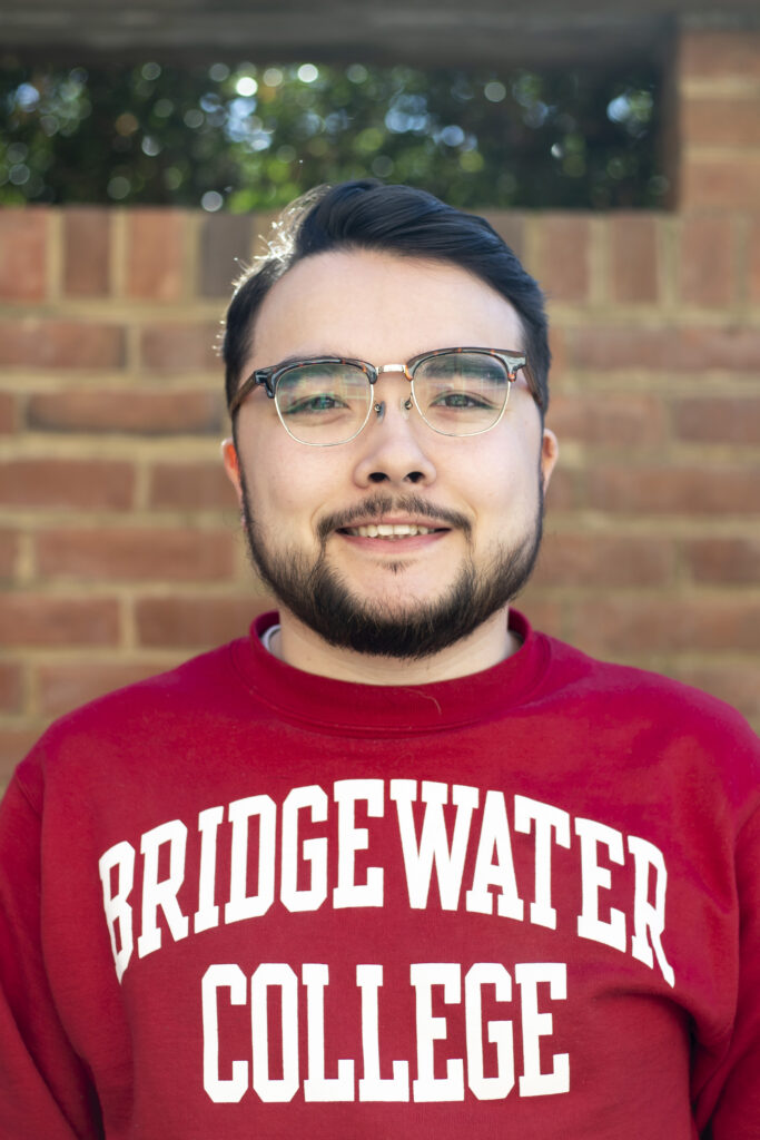 Portrait of Seiya Nomura in front of brick wall wearing Bridgewater College sweatshirt