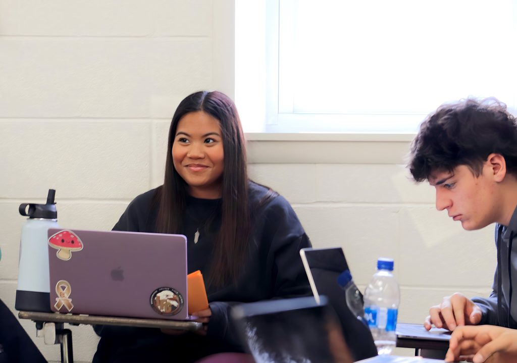 Two teacher education students take notes on their laptop during a lecture in Dr. Martin's Educational Psychology class. 