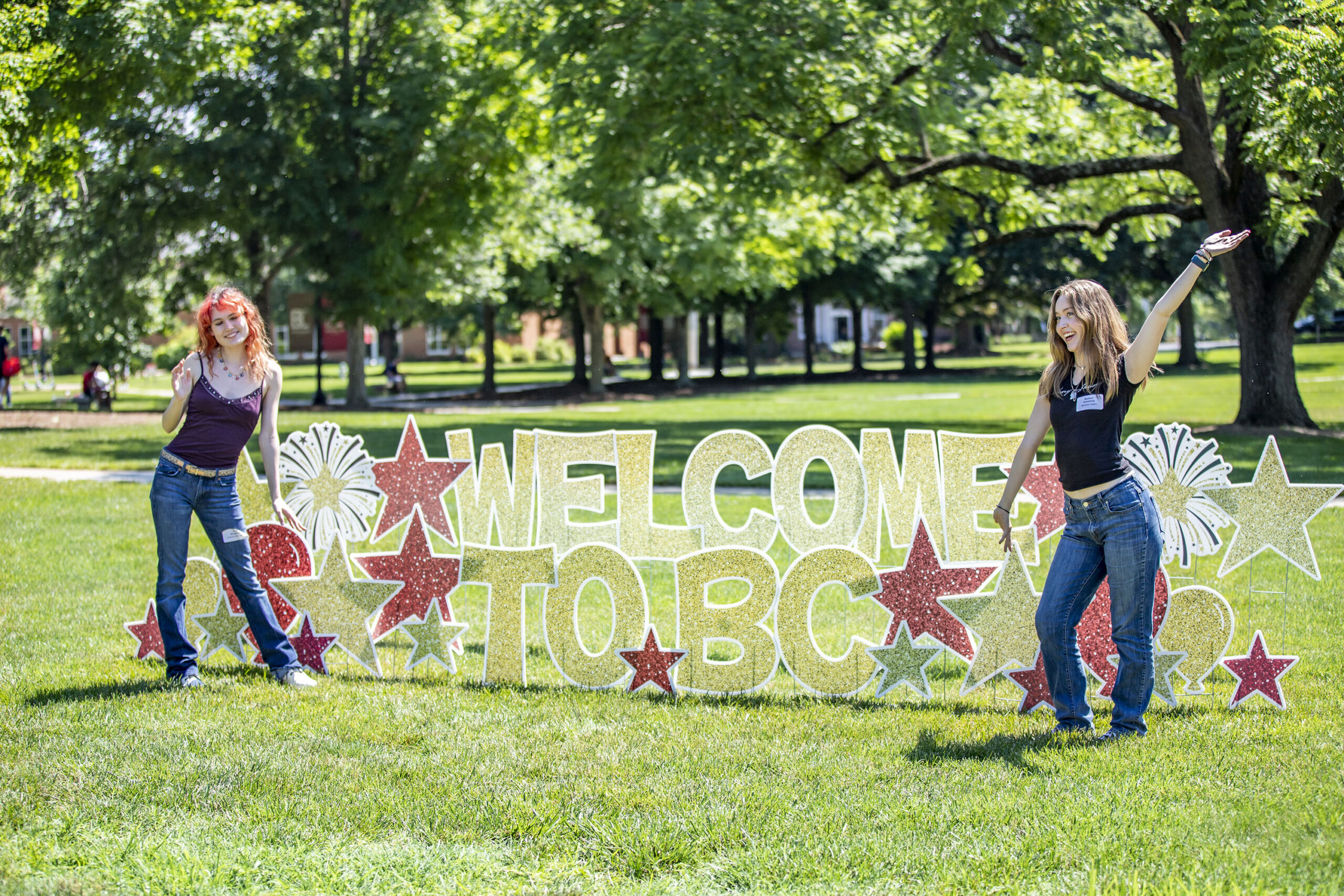 Two girls posing in front of Welcome to BC letter sign