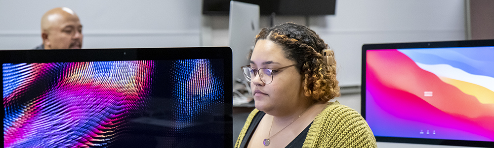 Student working at computer in a digital media class