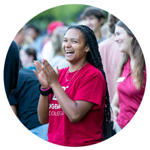 Student wearing B-C shirt clapping and smiling