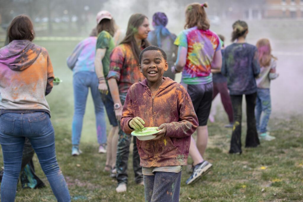 Child participating in Holi event held on campus