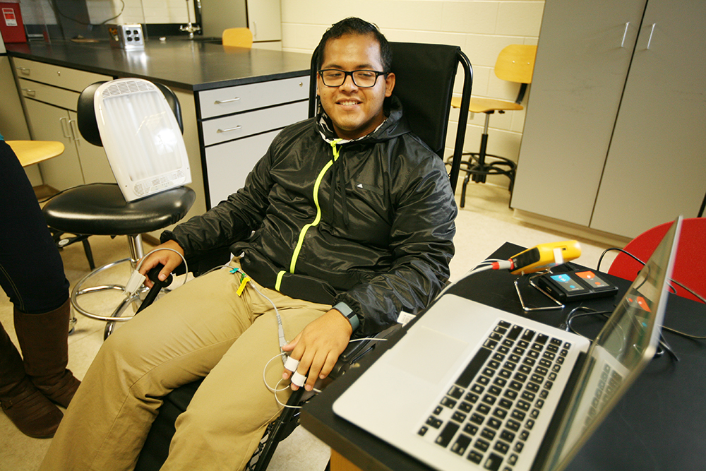 Student in psychology class hooked up to computer