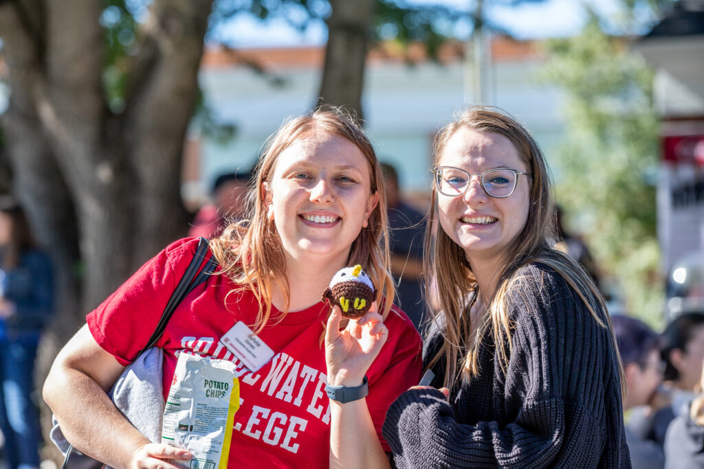 Staff members smiling for a photo at a campus event