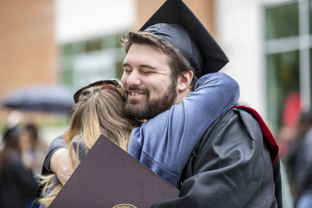 Graduated student hugging someone at commencement