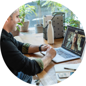 Person participating in online meeting on a laptop