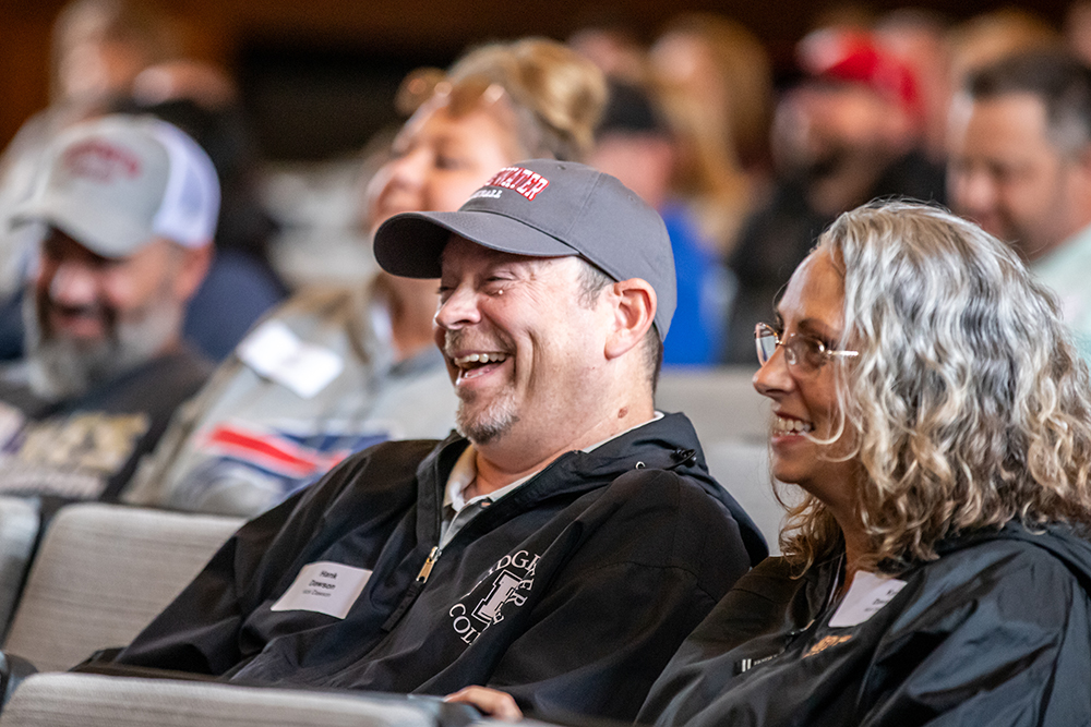 Parent wearing Bridgewater hat smiling during a parent session 