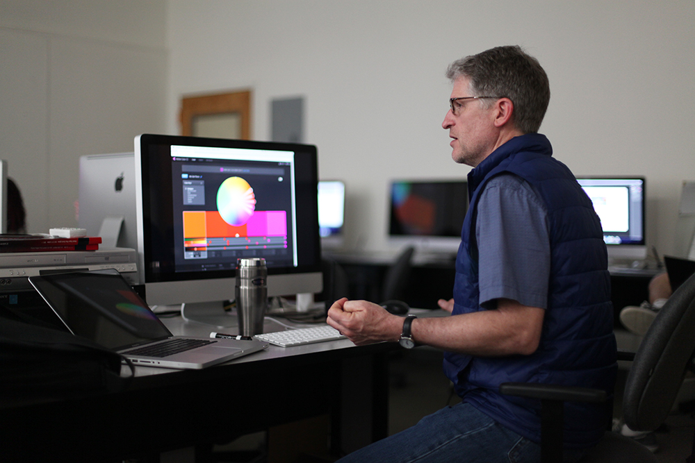 Person working at computer with colorful image on the screen