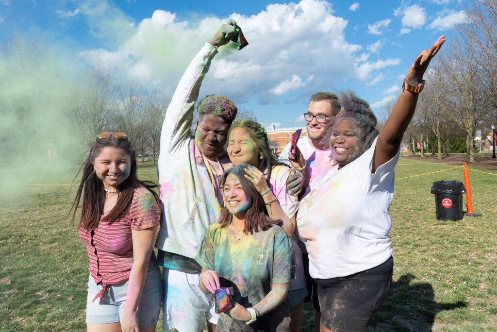 Group of student covered in colorful powder during Holi event
