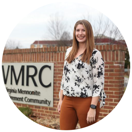 Portrait of Kaley Saxton standing in front of brick sign