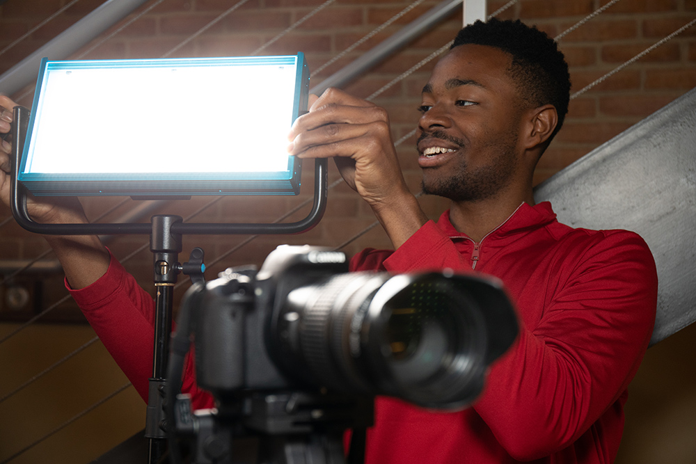 Person adjusting lighting equipment 