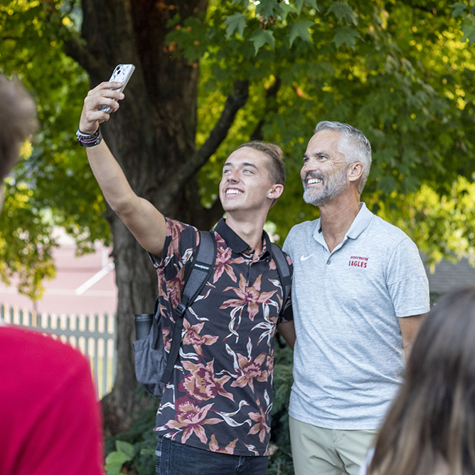 Student taking selfie with President Bushman