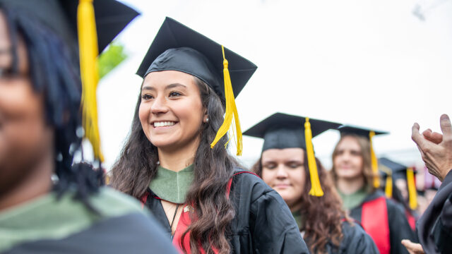 Student walking at commencement