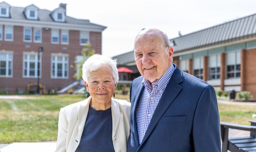 A photo of Rev. Wilfred Nolen and Dr. Joyce Nolen standing side-by-side smiling outside on Rebecca Quad