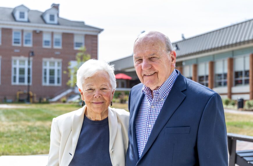 A photo of Rev. Wilfred Nolen and Dr. Joyce Nolen standing side-by-side smiling outside on Rebecca Quad