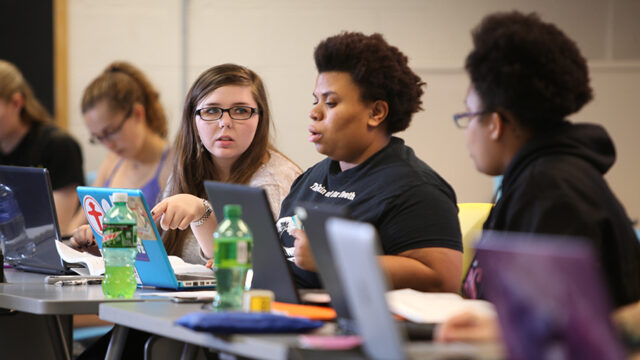 Student working on laptops in psychology class