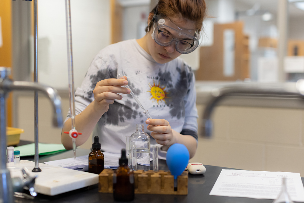 Student working with equipment in chemistry lab