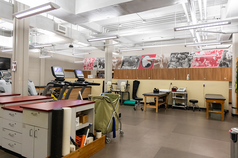 Athletic training room facilities with tables treadmills and more