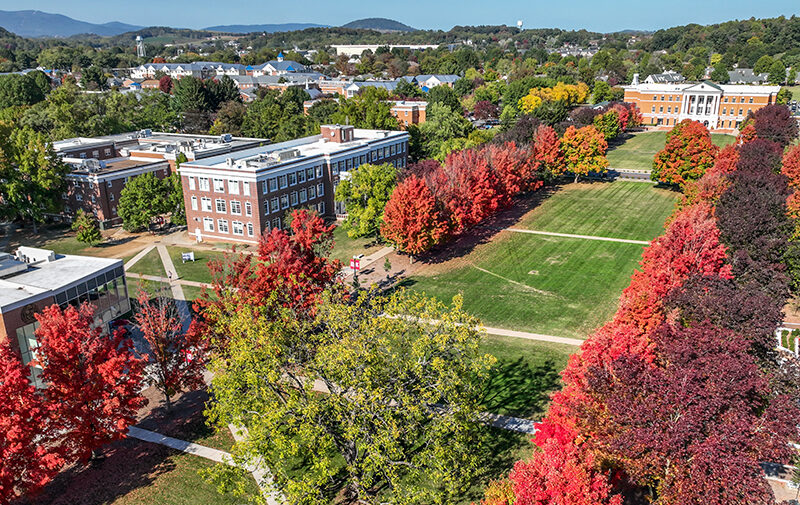 Drone shot of the campus mall during fall with crimson colored leaves