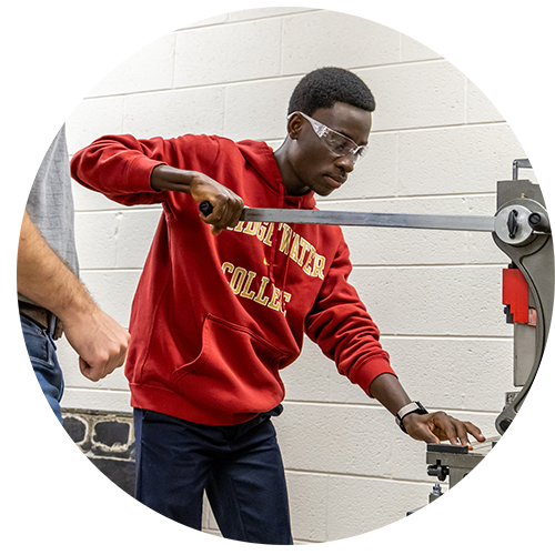 Student working with a piece of equipment in an engineering class