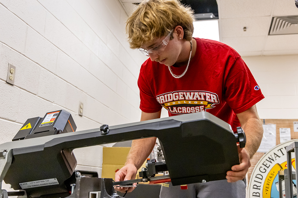 Student working with a piece of equipment in an engineering class