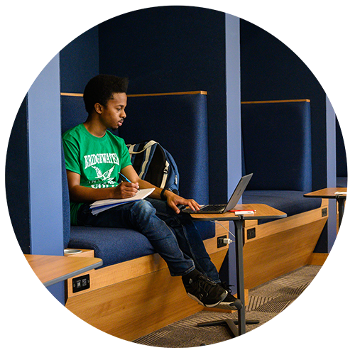 Student working in cubicle space in the F-L-C