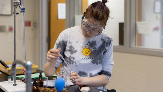 Student working with chemistry equipment