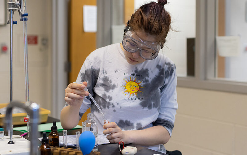 Student working with chemistry equipment