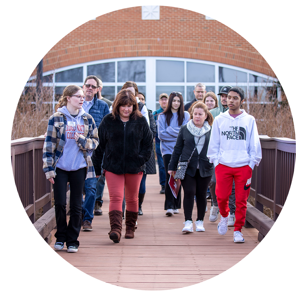 Group walking across a bridge during tour of campus