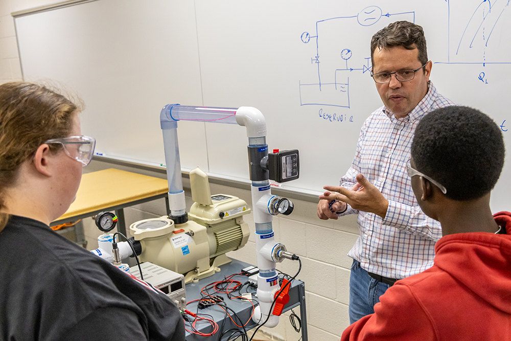 Engineering professor speaking to two students