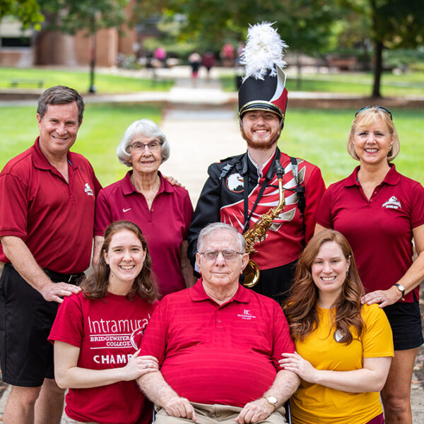 Joseph Wampler in a marching band uniform pictured with 6 family members all connected to Bridgewater College.