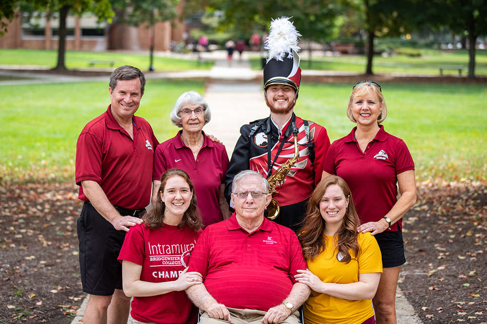 Joseph Wampler in a marching band uniform pictured with 6 family members all connected to Bridgewater College.