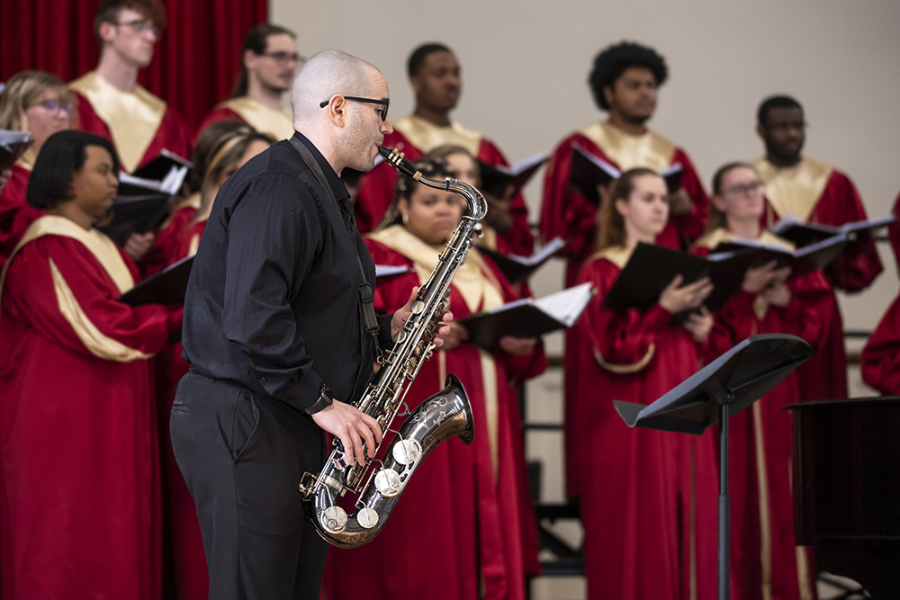 Anthony Cincotta playing the saxophone with choir in the background