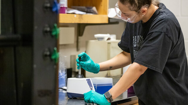 Student working with forensic chemistry lab equipment