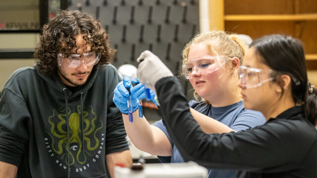 Three students working together in forensic chemistry lab