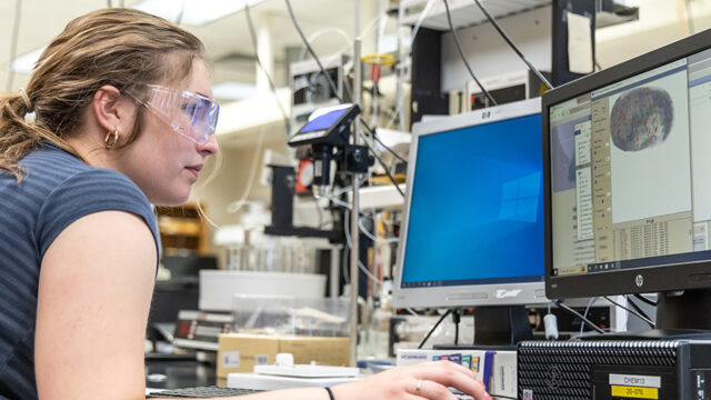 Student analyzing finger print on computer screen