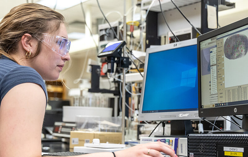 Student analyzing finger print on computer screen