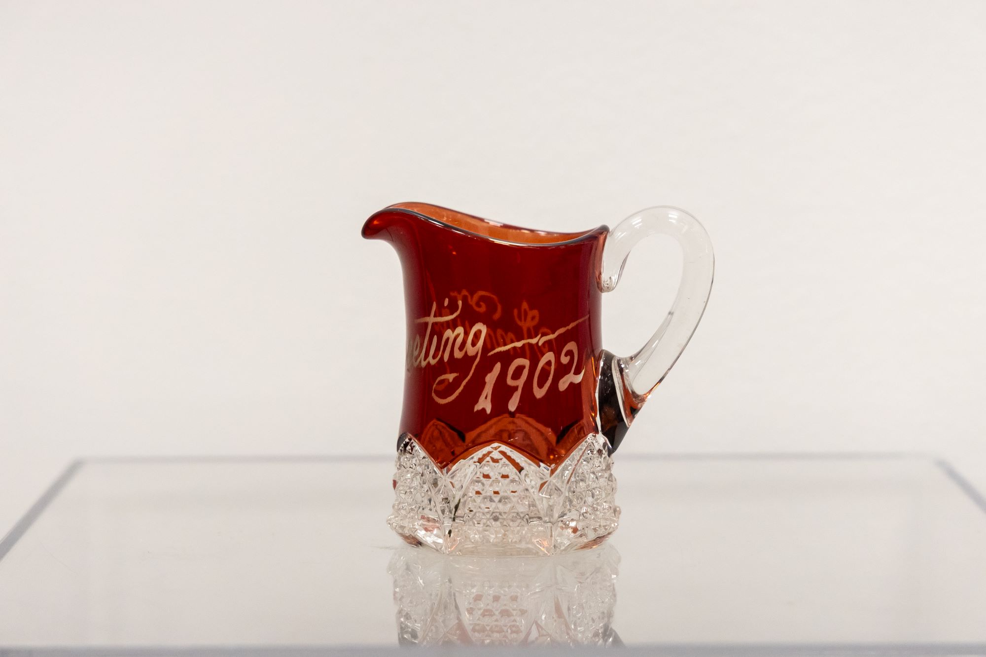 Miniature ruby ware glass pitcher, souvenir of the Brethren Annual Conference, 1902.