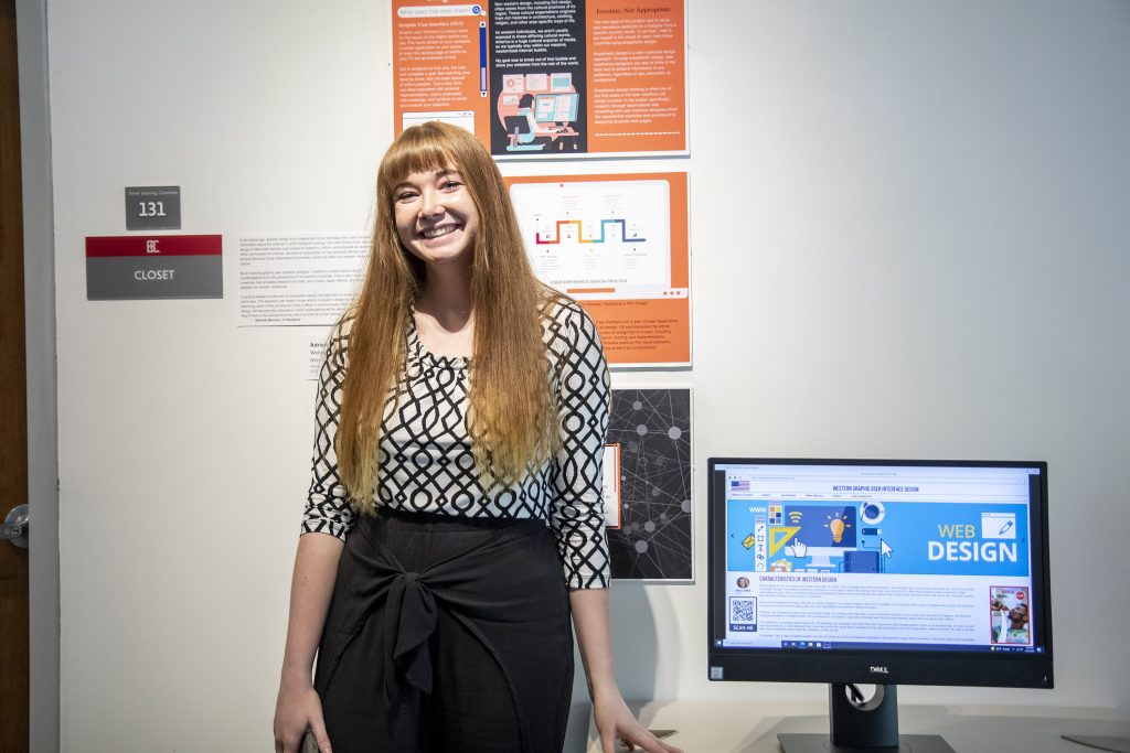 Design student in front of their portfolio