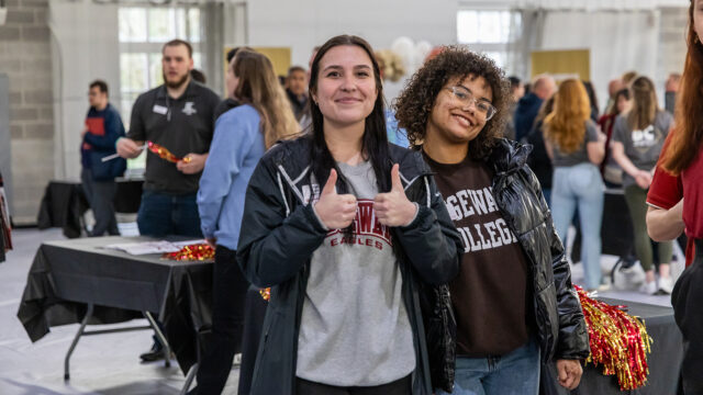 Students smiling and giving thumbs up